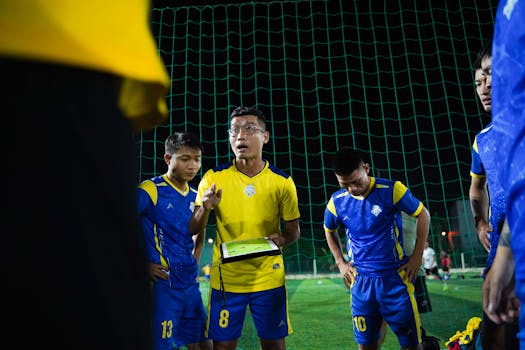 Soccer referee discussing with colleagues