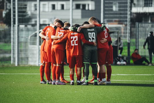 soccer players in a supportive huddle