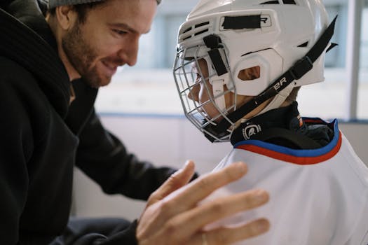 Father coaching son during practice