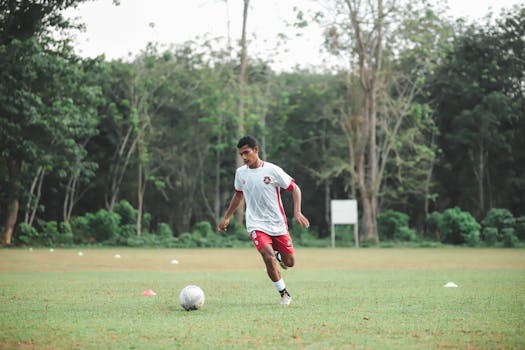 young soccer player practicing dribbling