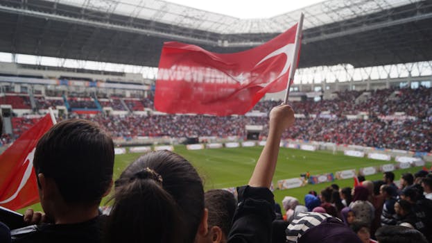 Excited fans cheering in a packed stadium