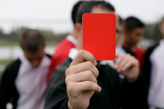 referee showing a yellow card